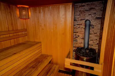 a sauna with a boiler and a tub in it at Luxury houses in Dobrinishte in Dobrinishte