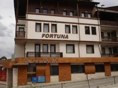 a tall building with a forfurma sign on it at Cozy Fortuna Apartments 46 in Bansko