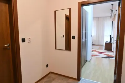 a hallway with a mirror and a door at Cozy Fortuna Apartments 46 in Bansko