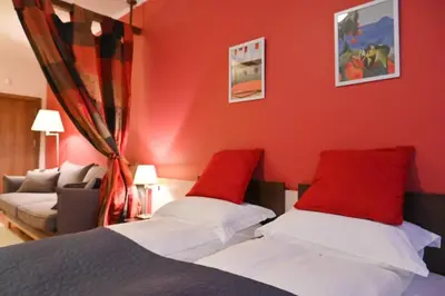 a bedroom with red walls and a bed with red pillows at Cozy Fortuna Apartments 46 in Bansko