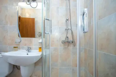 a bathroom with a sink and a glass shower at Studio - Apartments Castle Complex 2 in Pamporovo