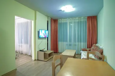 a living room with a couch and a table at Studio - Apartments Castle Complex 2 in Pamporovo