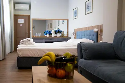 a hotel room with a bed and a couch at AquaSun Family Hotel in Sandanski