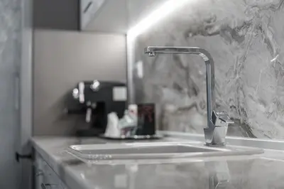 a kitchen counter with a sink and a faucet at City Apartments - a brand new luxury & comfy 2 in Asenovgrad