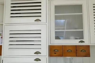 a white cabinet with a mirror in a kitchen at LUXURY PENTHOUSE WITH A LAVISH SPA and 2 en-suite bedrooms in Bansko