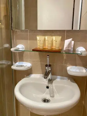 a white sink in a bathroom with a mirror at LUXURY PENTHOUSE WITH A LAVISH SPA and 2 en-suite bedrooms in Bansko