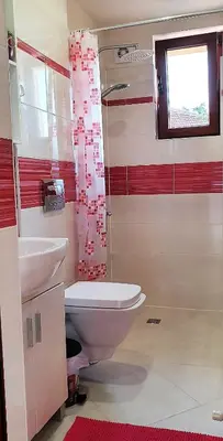 a bathroom with a toilet and a sink at ALBISTO Dragalevtsi Luxury Apartments in Sofia