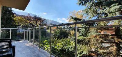 a balcony with a view of a garden at ALBISTO Dragalevtsi Luxury Apartments in Sofia
