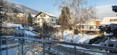 a view of a snow covered yard with houses at ALBISTO Dragalevtsi Luxury Apartments in Sofia