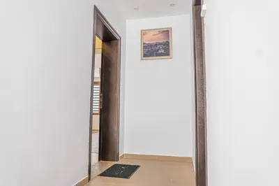 a hallway with a mirror and a framed picture on the wall at Shushi's Central Studio Apartment in Plovdiv
