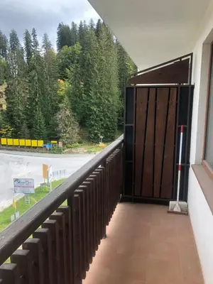 a door to a building with a view of a road at Апартамент Пампорово Палас - Pamporovo Palace in Pamporovo