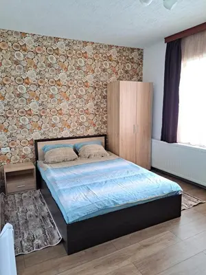a bedroom with a bed and a brick wall at Вила Слънчев Бряг in Dospat