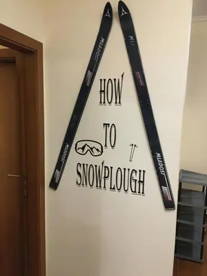three baseball bats hanging on a wall with the wordshow to snowchurch at 2 bedroom apartment near Gondola in Bansko