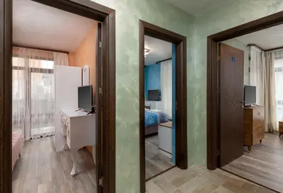 a room with a bedroom with a bed and a mirror at Къща за гости