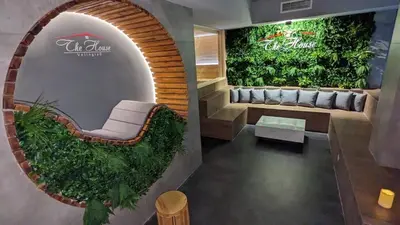 a room with a couch and a green wall at TheHouse - Apartment Kamenitza in Velingrad