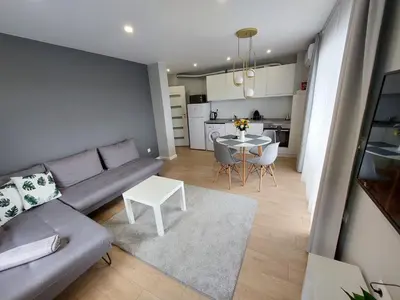 a living room with a couch and a table at TheHouse - Apartment Kamenitza in Velingrad