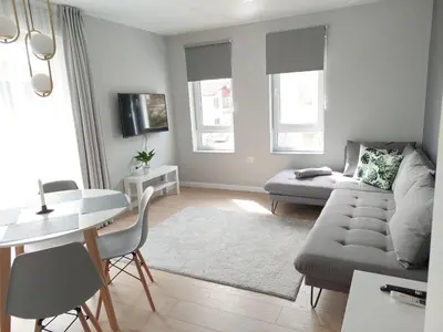 a living room with a couch and a table at TheHouse - Apartment Kamenitza in Velingrad