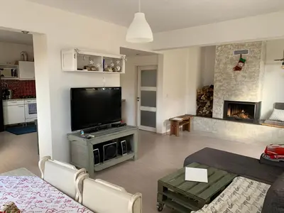 a living room with a television and a fireplace at Апартамент “МИЛА” in Troyan