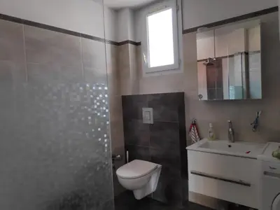 a bathroom with a toilet and a sink and a shower at Апартамент “МИЛА” in Troyan