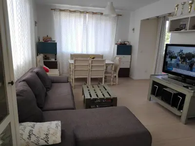 a living room with a couch and a television at Апартамент “МИЛА” in Troyan