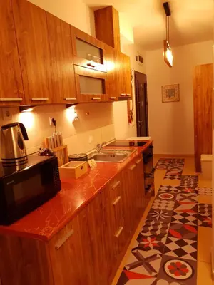 a kitchen with wooden cabinets and a microwave at Pinewood ANG Apartment, Semiramida Borovets Hills in Borovets