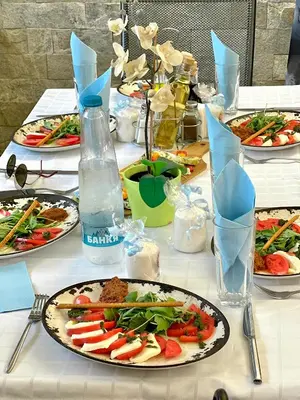 a table with plates of food on it at Хотел Дива in Blagoevgrad