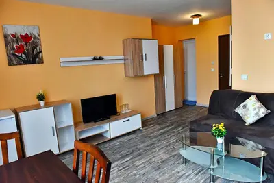 a living room with a couch and a table at Хотел Дива in Blagoevgrad