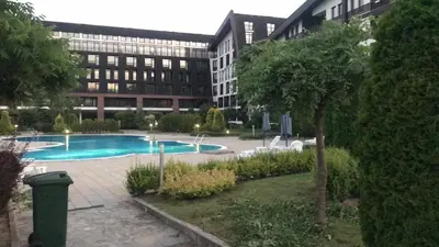 a large building with a swimming pool in a courtyard at Aspen Valley in Razlog