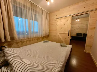 a bedroom with a large bed with a window at Bansko Royal Towers - Studio 945 in Bansko