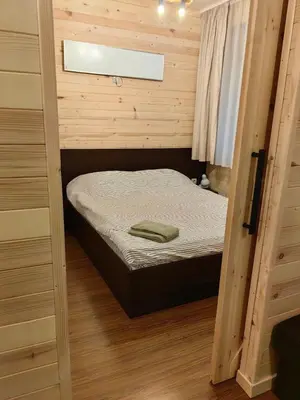 a small bedroom with a bed in a wooden room at Bansko Royal Towers - Studio 945 in Bansko
