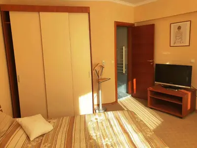 a hotel room with a bed and a television at апартамент Манастира 1 in Pamporovo