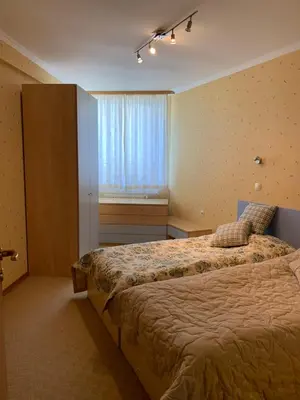 a bedroom with a large bed and a window at апартамент Манастира 1 in Pamporovo