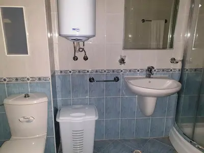 a small bathroom with a toilet and a sink at апартамент Манастира 1 in Pamporovo