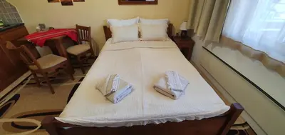 a bedroom with a bed with two towels on it at Луксозно студио в Банско - малко кътче от рая. in Bansko