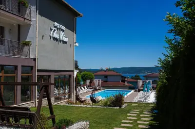 a building with a swimming pool next to a resort at Family Hotel The View & SPA in Tsigov Chark