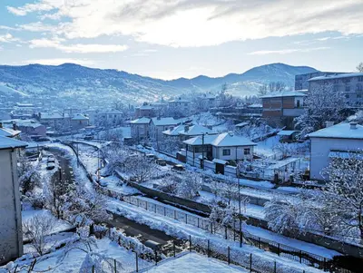 a town covered in snow with a train tracks at Stylish loft studio with great view to Ardino in Ardino