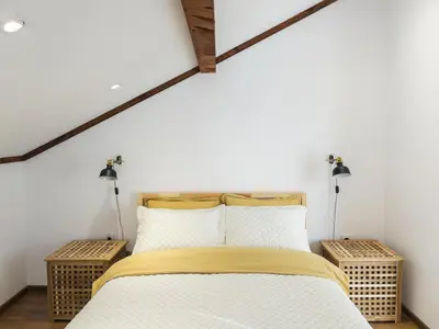 a bedroom with a bed with two lights on the wall at Stylish loft studio with great view to Ardino in Ardino