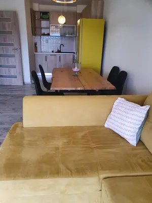 a table and a couch in a room with a dining room at New Apartment at a Great Location in Blagoevgrad