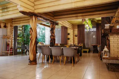 a restaurant with a table and chairs in a room at Власовъ in Pamporovo