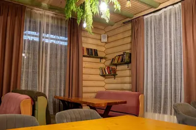 a room with tables and chairs and a window at Власовъ in Pamporovo