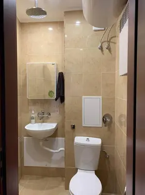 a small bathroom with a toilet and a sink at апартамент Гигови in Bansko