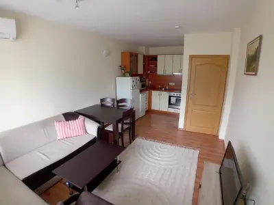 a living room with a white couch and a table at Cosy Apartment with terrace Eagle Rock in Beli Iskar