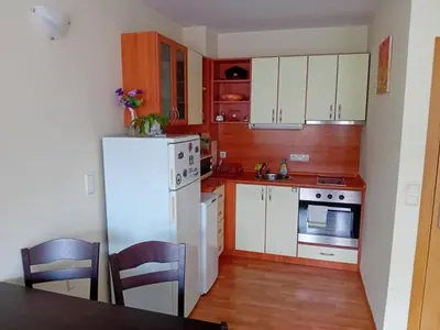 a kitchen with white cabinets and a white refrigerator at Cosy Apartment with terrace Eagle Rock in Beli Iskar