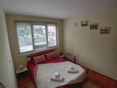 a bedroom with a bed with two towels on it at Cosy Apartment with terrace Eagle Rock in Beli Iskar