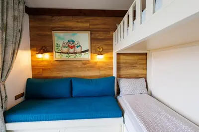 a bed in a tiny house at Mountain villa Aleksia- with JACUZZI in Razlog