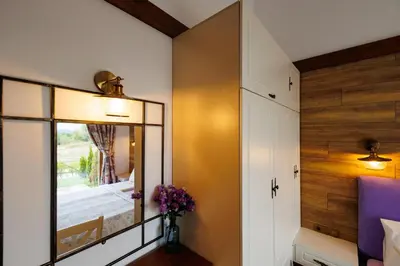 a bedroom with a mirror and a wooden wall at Mountain villa Aleksia- with JACUZZI in Razlog