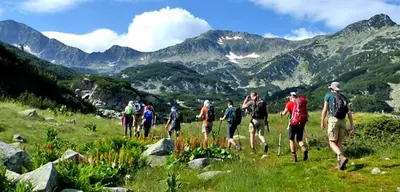 a group of people walking on a mountain trail at Mountain villa Aleksia- with JACUZZI in Razlog