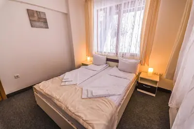 a small bed in a room with a window at Grand Monastery Violet Apartment With One Bedroom And A Terrace in Pamporovo