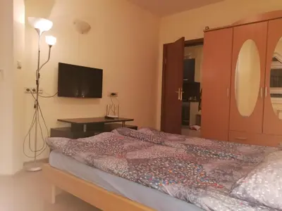 a bedroom with a bed and a television in it at BOROVETS Royal Plaza - A405 in Borovets