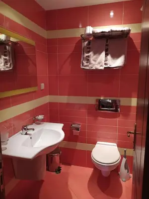 a bathroom with a white sink and a toilet at BOROVETS Royal Plaza - A405 in Borovets